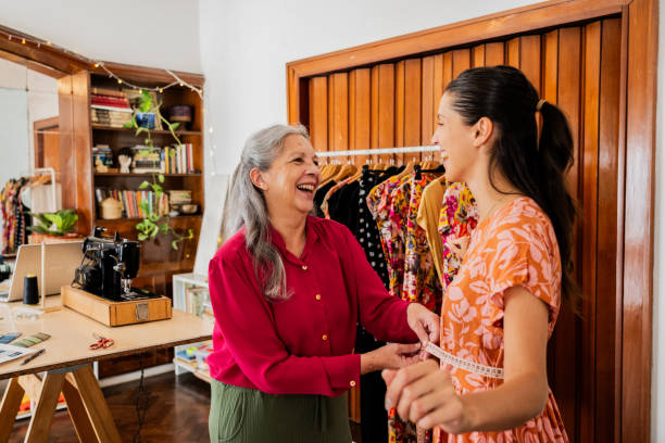 istock Seamstress taking measurements and talking customer on an atelier 2149813036