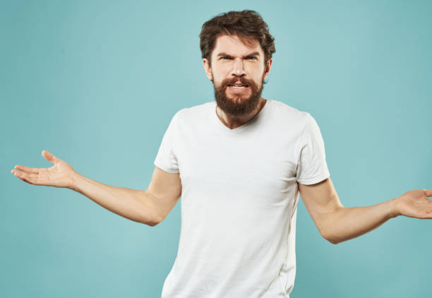 istock Cute man on a blue background gestures with his hands stress Scream irritability outrage 2149813305