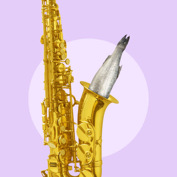 istock Contemporary art collage. Musical instrument, saxophone with fish looking inside it. Exploration of sound and its connection to nature 2149813543