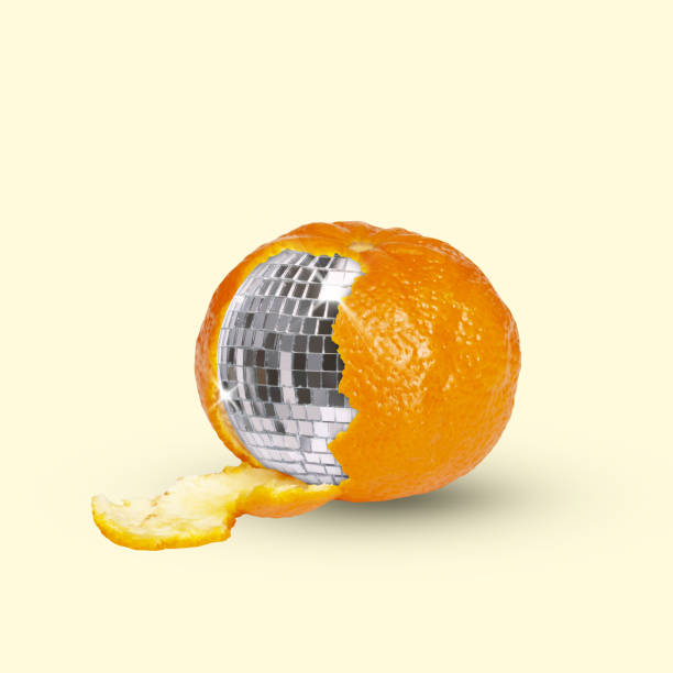 Contemporary art collage. Juicy mandarin with disco ball inside. Natural fruit with elements of celebration.