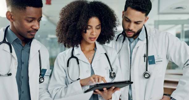 istock Tablet, team doctors and woman typing, reading or teamwork on medicine study, cardiology research or healthcare. Cooperation, hospital and medical surgeon, nurse or clinic group review online service 2149813702