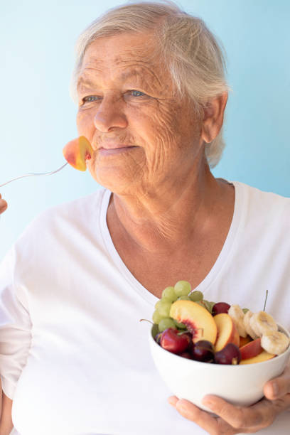 istock Old Woman Eating Fruit Salad 2149815335