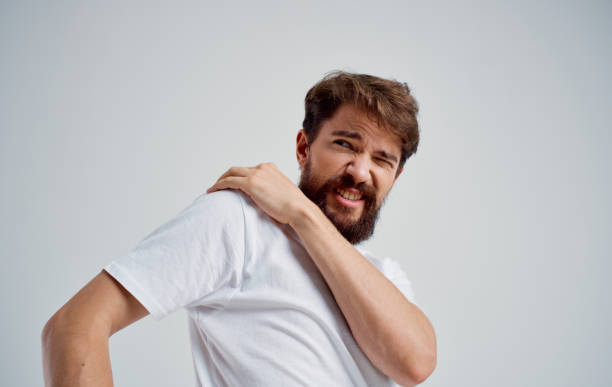 istock man touching shoulder with hand dislocation discomfort white t-shirt 2149815702