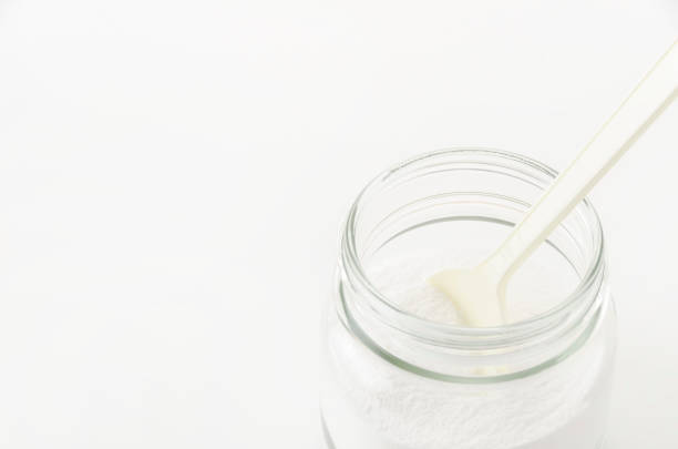 istock Baking soda in a Glass jar with a plastic spoon on white background 2149816126