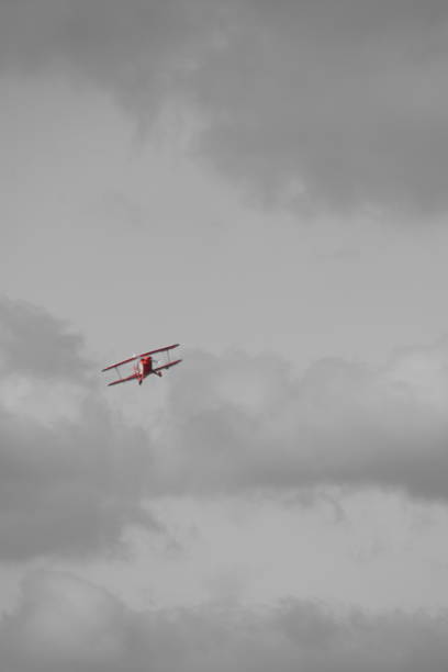small plane doing pirouettes in the cloudy sky