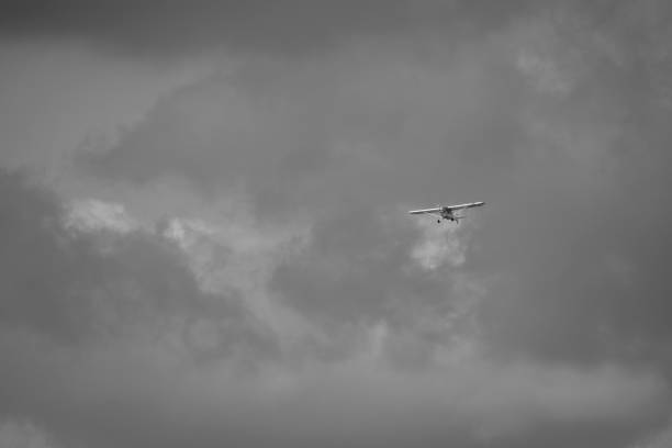 istock small plane doing pirouettes in the cloudy sky 2149816754