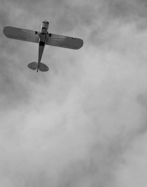 small plane doing pirouettes in the cloudy sky