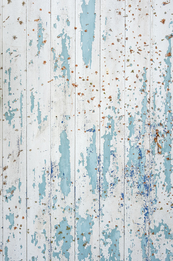 Wooden fence with peeling wooden paint