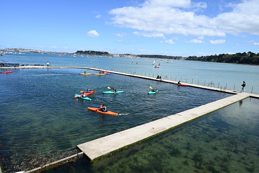 Dinard, France, april 18, 2024 : Kayakers in the seawater swimming pool of the Priory