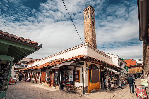 15 March 2024, Sarajevo, Bosnia and Herzegovina: Iconic Sahat Tower rises majestically amidst Sarajevo's historic bazaar, a must-see attraction blending Ottoman charm with European allure.
