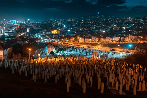 15 March 2024, Sarajevo, Bosnia and Herzegovina: Amidst the twilight glow, the cemetery in Sarajevo pays homage to the countless lives, each gravestone telling a story