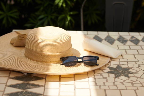 istock Sunglasses, Sunscreen and Straw Hat on Tiled Floor 2149822419