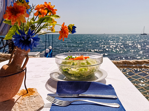 Salad on Table in Traditional Mediterranean Restaurant with Blue Adriatic Sea in the Background