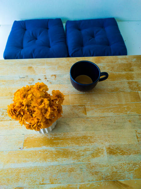 Morning Coffee Cup and Fresh Marigold Flower Set on Table