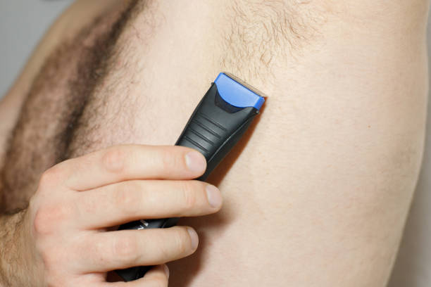 istock Male depilation. man using razor to remove hair from his armpit 2149825601