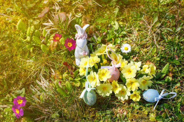 Easter bunny with Easter eggs on the green lawn