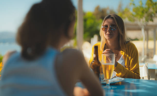 istock Two girls talking in a bar. 2149826927