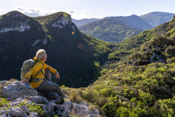 istock Senior hiker pauses on mountain top 2149827950