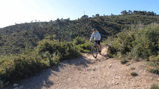 istock Young woman e-biking above hills 2149828175