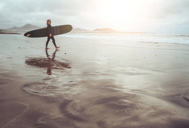 istock Surfer woman with longboard surfboard 2149829756