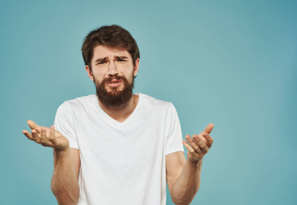 istock guy with bushy beard on blue background gesturing with hands cropped view Copy Space 2149829898