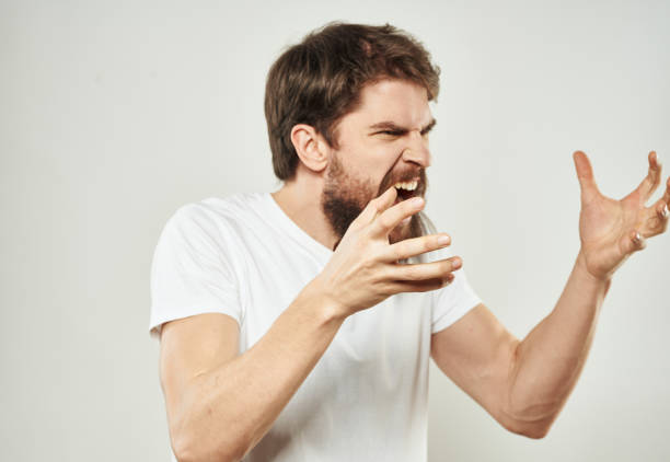 istock Aggressive man gestures with his hands on a light background stress emotions irritability 2149830270