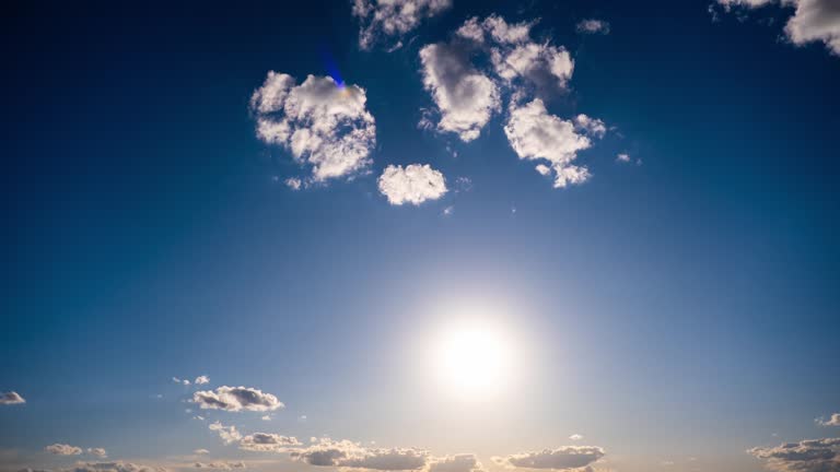 Timelapse of Cumulus Clouds Moving In The Blue Sky Against The Sun