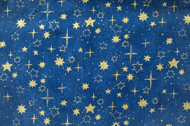 Golden stars in deep blue sky printed on woven fabric