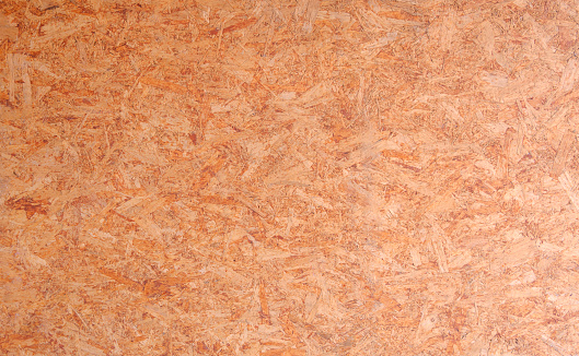 Seamless compressed wood particle board texture background. OSB oriented strand wooden board backdrop.