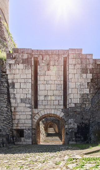 Vertical shot capturing the northern entrance and hidden tunnel from Strada del Soccorso with a stone staircase leading to Brescia Castle, Italy
