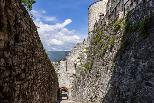 The Strada del Soccorso at Brescia Castle carves a historic path upwards, where the stone steps meet the Pre Alps view peeking over the fortress walls
