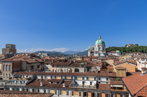 Panorama of Brescia historic center with dome of the Cathedral of Santa Maria Assunta, Torrione INA and the distant medieval castle