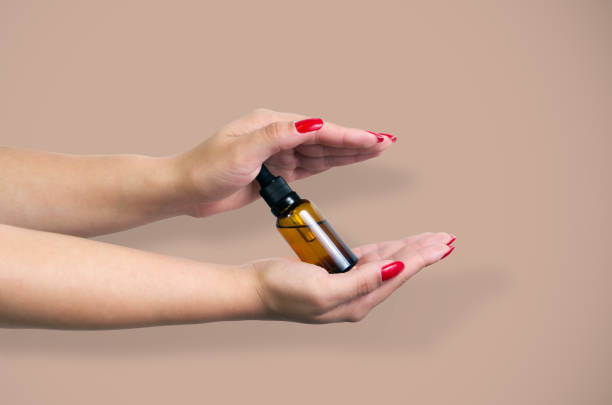 istock Product package with serum and a woman hand in studio 2149834849