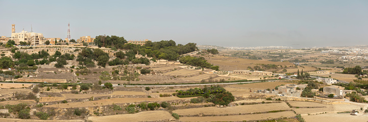 Panoramic view of a maltese landscape with agricultural fields near the medieval town of Mdina.