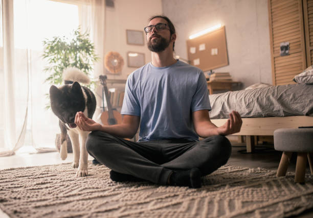 istock man meditating with his pet dog 2149836629