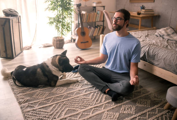 istock man meditating with his pet dog 2149836642