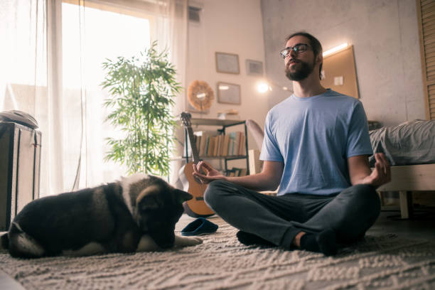 istock man meditating with his pet dog 2149836651