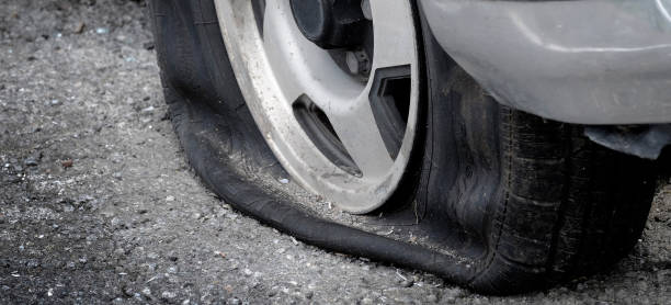 istock Flat Tire Vehicle Car on Road Danger Dangerous Stranded Deflated 2149837203