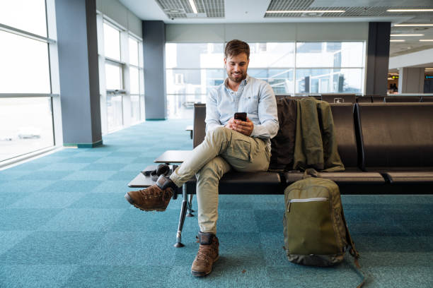istock Millennial business traveler at the airport using smart phone and internet data while waiting 2149837798