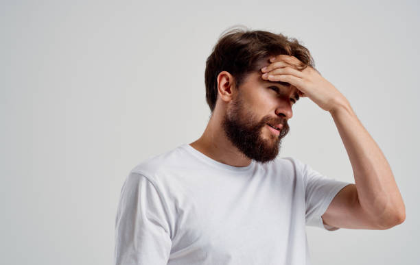 istock bearded man holding his head pain health problems close-up 2149837947