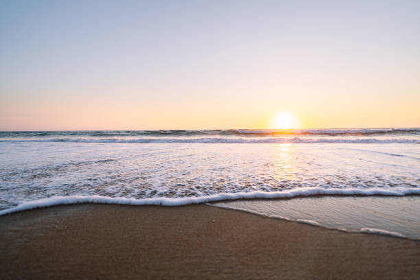 istock Sunset Horizon Over Gentle Sea Waves at Sandy Beach 2149840113