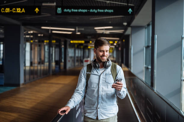 istock Millennial business traveler at the airport using smart phone and internet data while waiting 2149840329