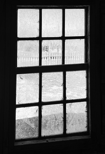 Looking through a window in an abandoned home in a ghost town