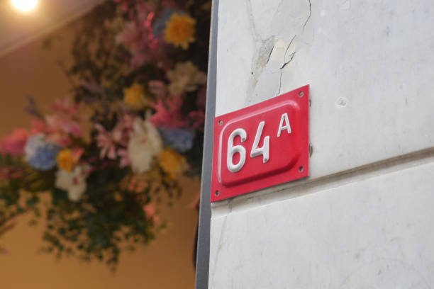 istock house number. Decorative lettering on a brick wall. 2149840581