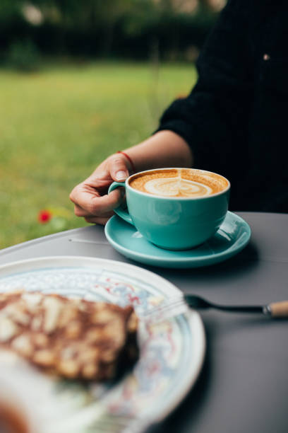 istock Woman holding a cup of latte 2149840725