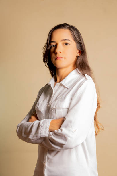 istock young business woman dressed casually elegant crossing arms looking seriously in front on neutral background, studio shot 2149840802