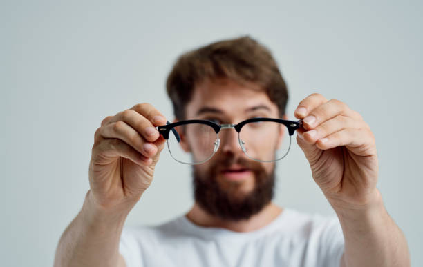 istock a man with glasses in his hand vision problems eye pain myopia hyperopia lenses 2149840839