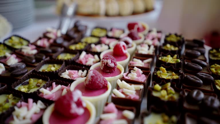 Close-up of delicious desserts on event buffet tables, forward motion