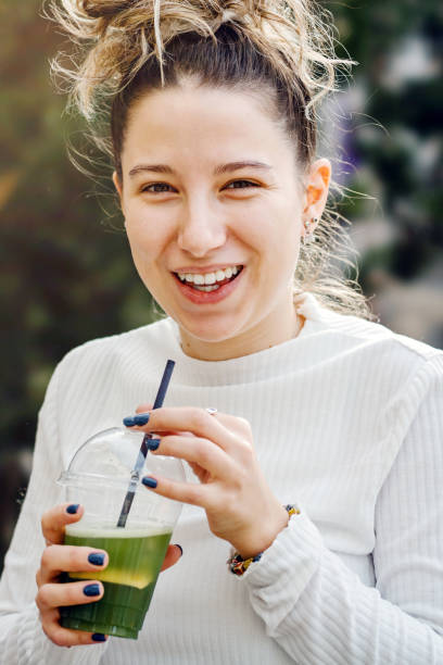 istock Cheerful woman drinking smoothie 2149842681