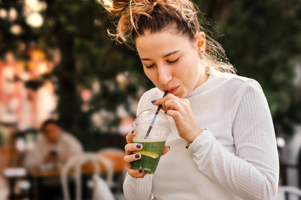 istock Cheerful woman drinking smoothie 2149842682